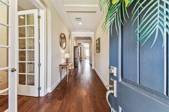 4133 Foxhound Dr, Clermont, FL 34711 - foyer entrance featuring crown molding, dark wood-type flooring, and arched walkways