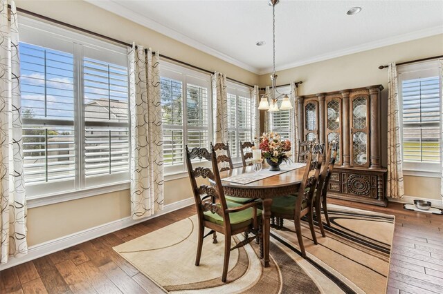 4133 Foxhound Dr, Clermont, FL 34711 - dining area featuring hardwood / wood-style floors, crown molding, and a chandelier