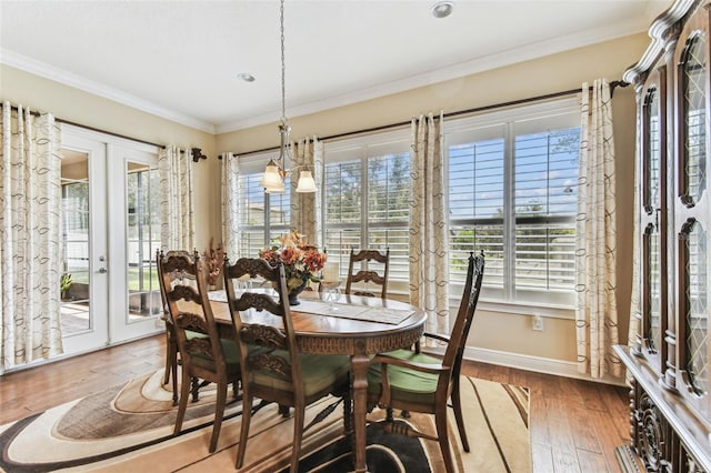 4133 Foxhound Dr, Clermont, FL 34711 - dining space with french doors, wood-type flooring, crown molding, and recessed lighting