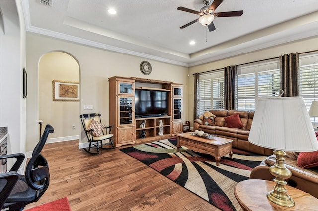 4133 Foxhound Dr, Clermont, FL 34711 - living area with a raised ceiling, hardwood / wood-style flooring, ceiling fan, arched walkways, and recessed lighting