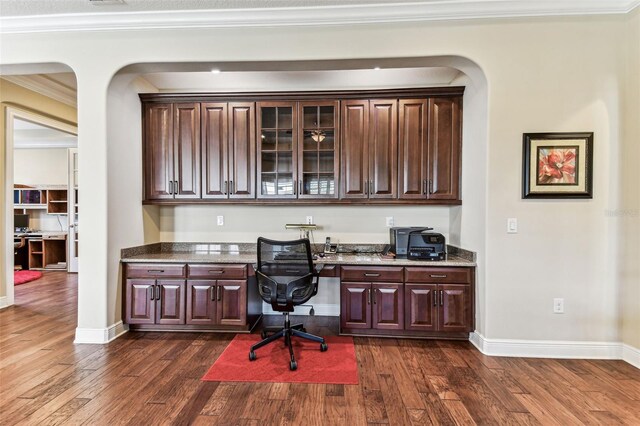 4133 Foxhound Dr, Clermont, FL 34711 - office space with built in study area, dark wood-style flooring, crown molding, and arched walkways