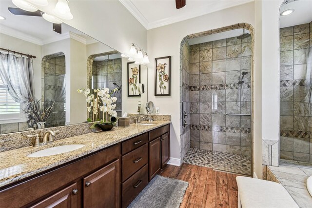 4133 Foxhound Dr, Clermont, FL 34711 - full bath with double vanity, tiled shower, wood finished floors, ornamental molding, and recessed lighting
