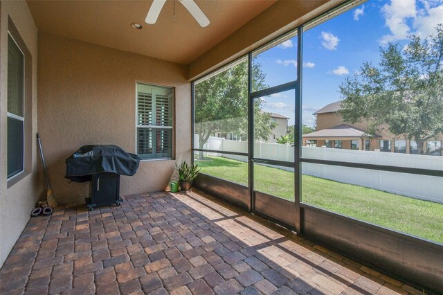 4133 Foxhound Dr, Clermont, FL 34711 - unfurnished sunroom with a ceiling fan
