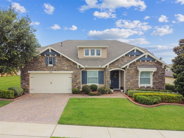 4133 Foxhound Dr, Clermont, FL 34711 - craftsman inspired home featuring stone siding, decorative driveway, a front lawn, and a shingled roof