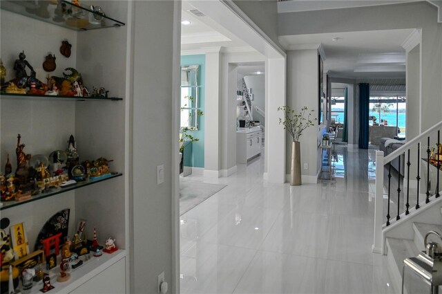 7550 John Hancock Dr, Winter Garden, FL 34787 - bar featuring ornamental molding, stairway, tile patterned floors, and baseboards