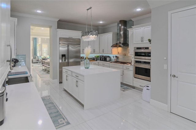 7550 John Hancock Dr, Winter Garden, FL 34787 - kitchen featuring wall chimney exhaust hood, appliances with stainless steel finishes, tasteful backsplash, ornamental molding, and white cabinets