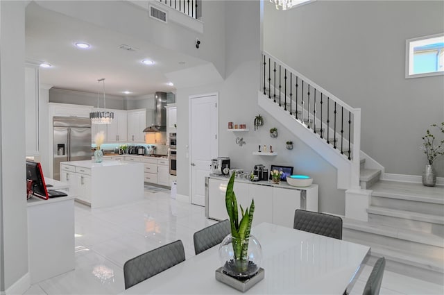 7550 John Hancock Dr, Winter Garden, FL 34787 - dining space featuring stairway, a towering ceiling, recessed lighting, baseboards, and light tile patterned flooring