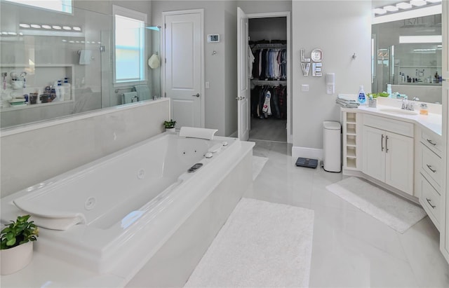 7550 John Hancock Dr, Winter Garden, FL 34787 - bathroom featuring a stall shower, vanity, a whirlpool tub, tile patterned flooring, and baseboards