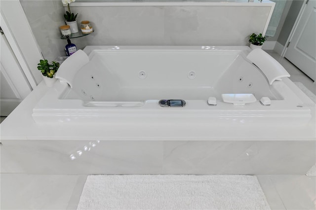 7550 John Hancock Dr, Winter Garden, FL 34787 - full bathroom with a jetted tub and tile patterned floors