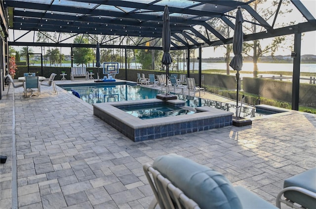 7550 John Hancock Dr, Winter Garden, FL 34787 - view of swimming pool featuring glass enclosure, a patio area, a water view, and a pool with connected hot tub