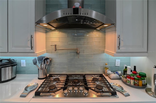 7550 John Hancock Dr, Winter Garden, FL 34787 - kitchen with extractor fan, light countertops, stainless steel gas stovetop, and decorative backsplash