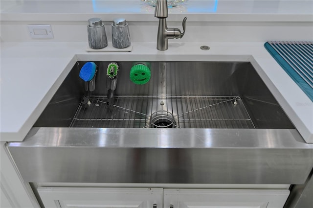 7550 John Hancock Dr, Winter Garden, FL 34787 - kitchen view of a sink, light countertops, and white cabinetry