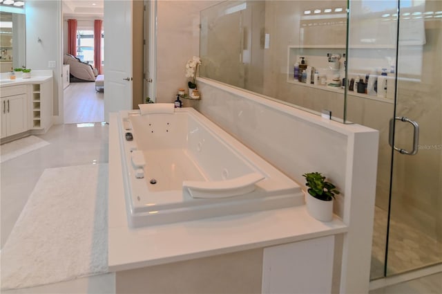 7550 John Hancock Dr, Winter Garden, FL 34787 - ensuite bathroom with a stall shower, a jetted tub, vanity, and tile patterned floors