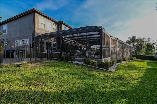 7550 John Hancock Dr, Winter Garden, FL 34787 - rear view of property with stucco siding, glass enclosure, and a patio