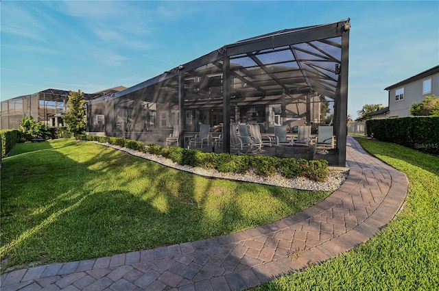 7550 John Hancock Dr, Winter Garden, FL 34787 - rear view of property featuring a lawn, a patio, and glass enclosure