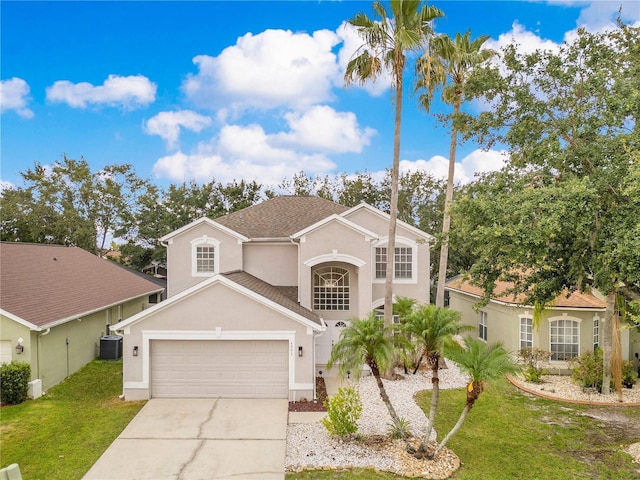 4993 Hook Hollow Cir, Orlando, FL 32837 - view of front of home featuring stucco siding, a front yard, central AC, a garage, and driveway