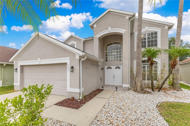 4993 Hook Hollow Cir, Orlando, FL 32837 - view of front of home featuring stucco siding, a garage, and driveway