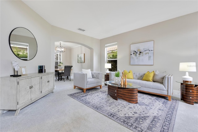 4993 Hook Hollow Cir, Orlando, FL 32837 - living area with light carpet, arched walkways, and a chandelier