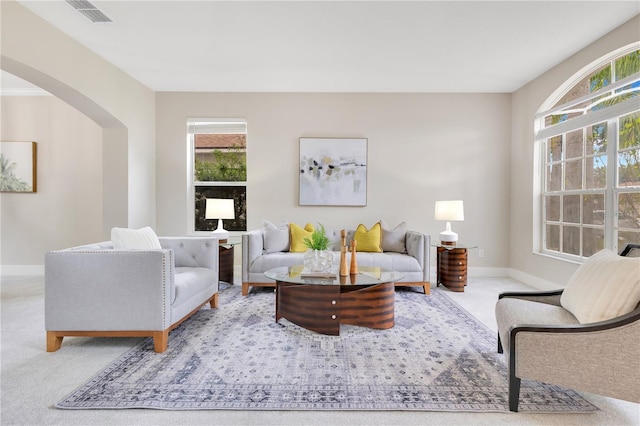 4993 Hook Hollow Cir, Orlando, FL 32837 - living area featuring carpet floors, arched walkways, and baseboards
