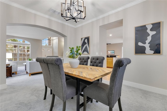 4993 Hook Hollow Cir, Orlando, FL 32837 - dining room featuring a chandelier, light carpet, arched walkways, crown molding, and baseboards