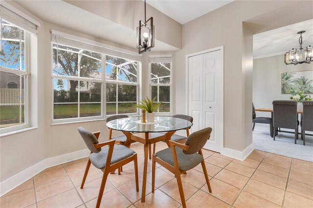 4993 Hook Hollow Cir, Orlando, FL 32837 - dining area featuring a chandelier, light tile patterned flooring, and baseboards