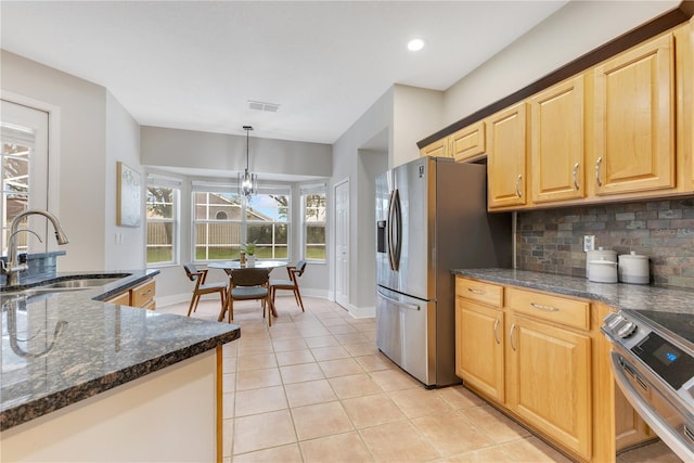 4993 Hook Hollow Cir, Orlando, FL 32837 - kitchen with a sink, stainless steel appliances, light tile patterned flooring, decorative backsplash, and dark stone countertops