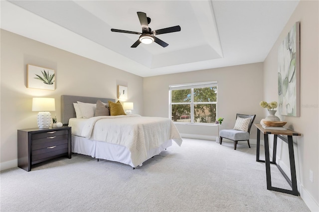4993 Hook Hollow Cir, Orlando, FL 32837 - carpeted bedroom featuring a tray ceiling, baseboards, and a ceiling fan