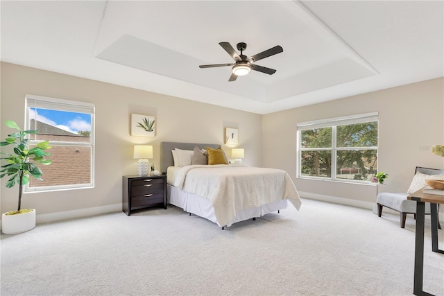 4993 Hook Hollow Cir, Orlando, FL 32837 - bedroom featuring a tray ceiling, light carpet, baseboards, and ceiling fan