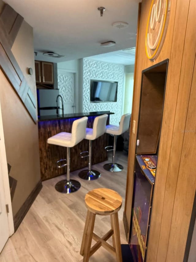 6165 Carrier Dr Unit 1801, Orlando, FL 32819 - bar area featuring light wood-style flooring and baseboards