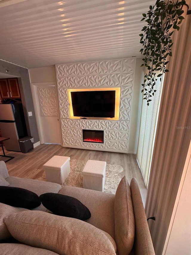 6165 Carrier Dr Unit 1801, Orlando, FL 32819 - living room with a tile fireplace, light wood-style flooring, and baseboards
