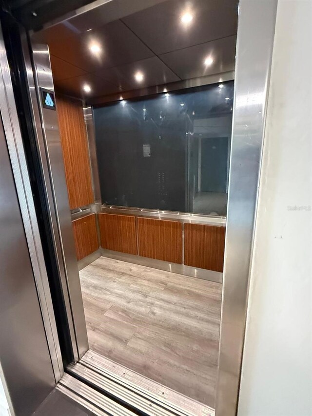 6165 Carrier Dr Unit 1801, Orlando, FL 32819 - elevator featuring wood finished floors and recessed lighting
