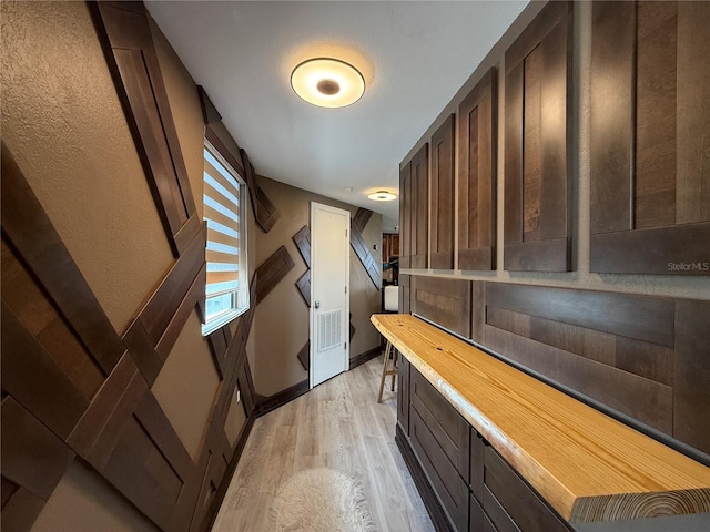 6165 Carrier Dr Unit 1801, Orlando, FL 32819 - bar featuring light wood-type flooring and a textured wall