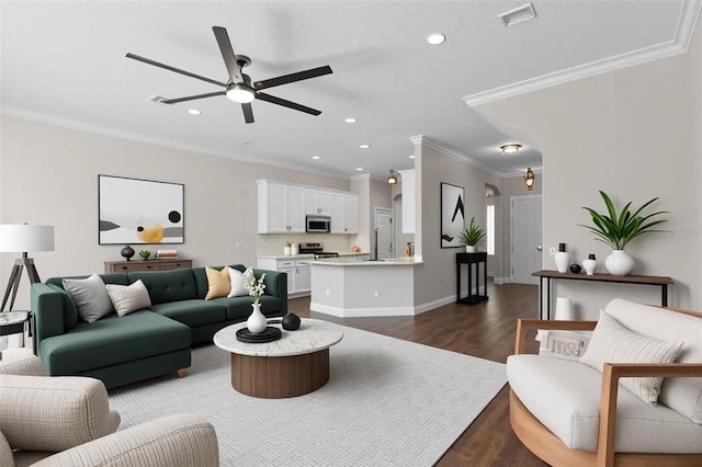 461 Black Knight Way, Longwood, FL 32779 - living area featuring ceiling fan, dark wood finished floors, arched walkways, ornamental molding, and recessed lighting