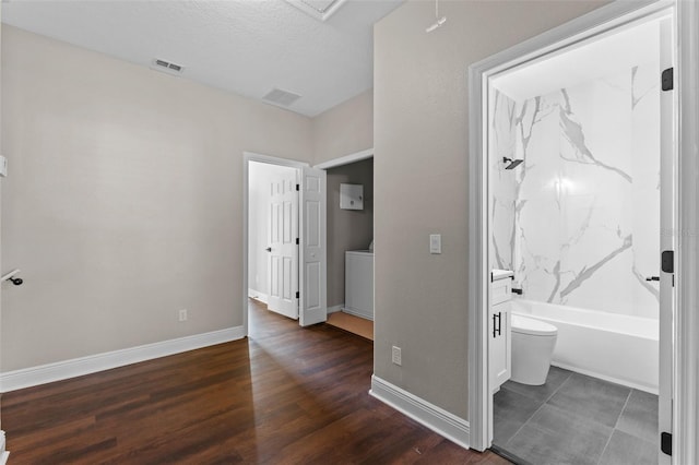 461 Black Knight Way, Longwood, FL 32779 - unfurnished bedroom featuring dark wood finished floors, baseboards, and ensuite bathroom