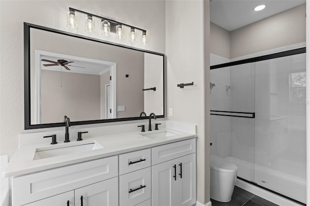 461 Black Knight Way, Longwood, FL 32779 - bathroom featuring a shower stall, double vanity, toilet, tile patterned flooring, and ceiling fan