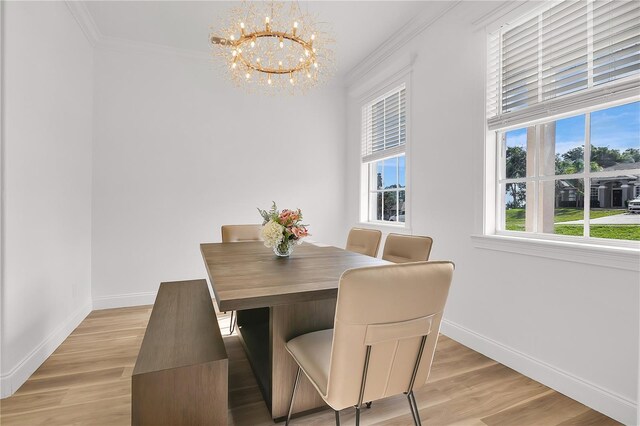 17657 Windy Pine St, Montverde, FL 34756 - dining area with a chandelier, ornamental molding, baseboards, and light wood-style floors