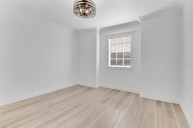 17657 Windy Pine St, Montverde, FL 34756 - empty room with light wood-style flooring, crown molding, a chandelier, and baseboards