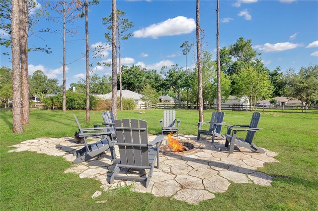 17657 Windy Pine St, Montverde, FL 34756 - view of yard with an outdoor fire pit, a patio, and view of wooded area