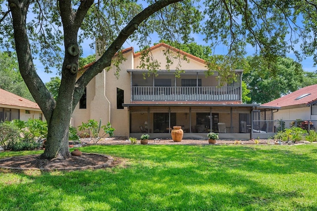 6460 Parson Brown Dr, Orlando, FL 32819 - rear view of property with a sunroom, a lawn, and stucco siding