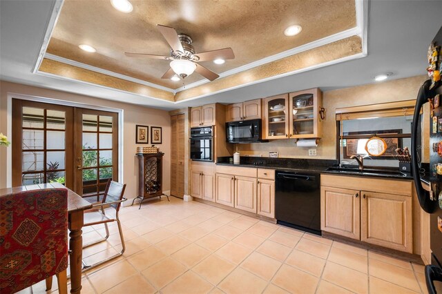 6460 Parson Brown Dr, Orlando, FL 32819 - kitchen featuring black appliances, a tray ceiling, a sink, dark countertops, and french doors