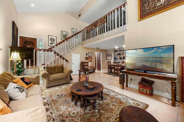 6460 Parson Brown Dr, Orlando, FL 32819 - tiled living area with stairs, high vaulted ceiling, and baseboards