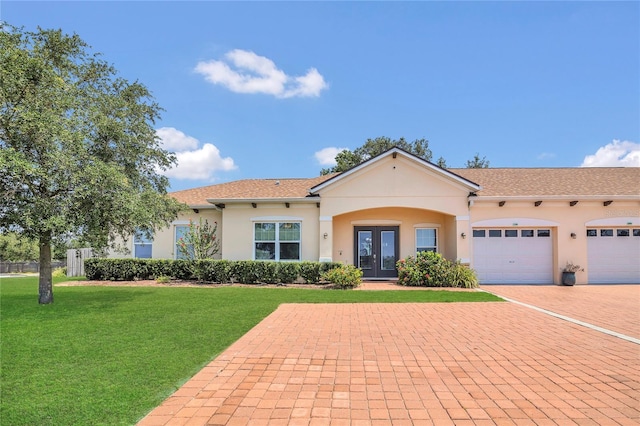 2100 Shantiniketan Blvd, Tavares, FL 32778 - view of front facade with french doors, a front yard, a garage, and stucco siding