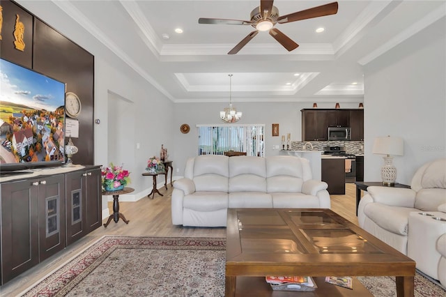 2100 Shantiniketan Blvd, Tavares, FL 32778 - living room featuring a ceiling fan, a chandelier, light wood-style flooring, a raised ceiling, and ornamental molding