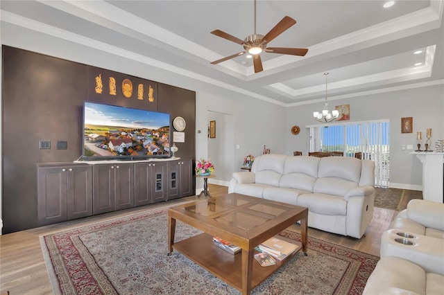 2100 Shantiniketan Blvd, Tavares, FL 32778 - living room featuring a tray ceiling, a ceiling fan, light wood-type flooring, a chandelier, and ornamental molding