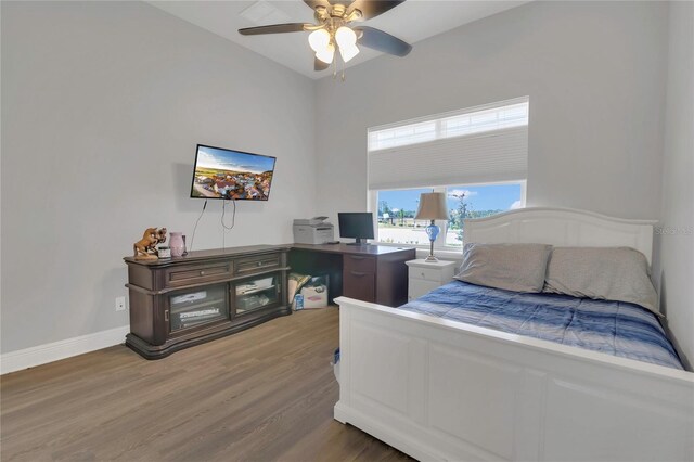 2100 Shantiniketan Blvd, Tavares, FL 32778 - bedroom featuring wood finished floors, baseboards, and a ceiling fan