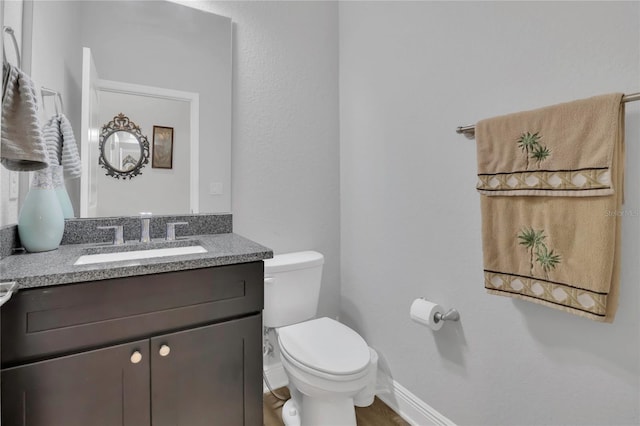 2100 Shantiniketan Blvd, Tavares, FL 32778 - half bathroom with toilet, vanity, and baseboards