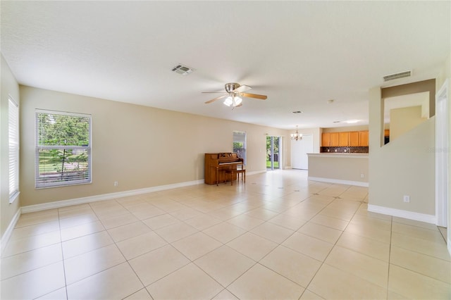 806 Sterling Spring Rd, Orlando, FL 32828 - unfurnished living room with a chandelier, a ceiling fan, light tile patterned floors, and baseboards