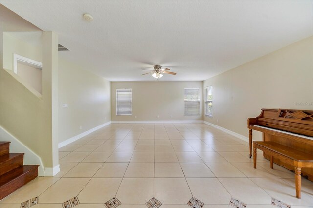 806 Sterling Spring Rd, Orlando, FL 32828 - empty room featuring ceiling fan, stairs, a smoke detector, baseboards, and light tile patterned floors