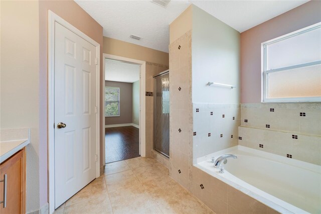 806 Sterling Spring Rd, Orlando, FL 32828 - full bath with a stall shower, a garden tub, vanity, and tile patterned flooring