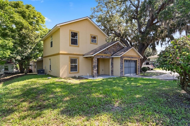 500 W Oakland Ave, Oakland, FL 34760 - view of front facade featuring stucco siding, central AC, a garage, stone siding, and a front yard